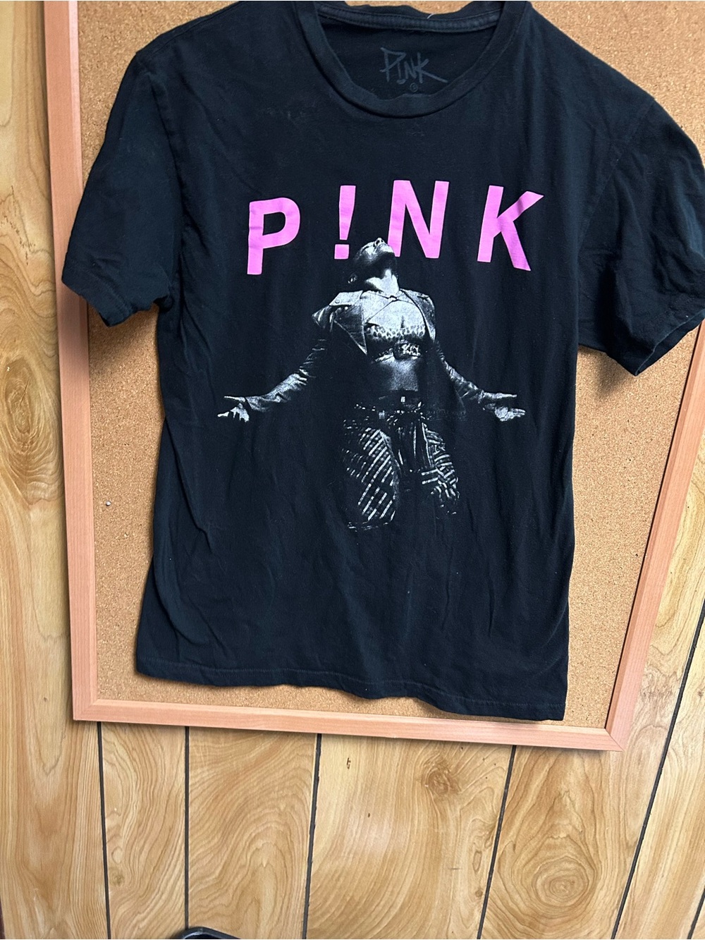 Black T-shirt with a picture of Singer pink on it